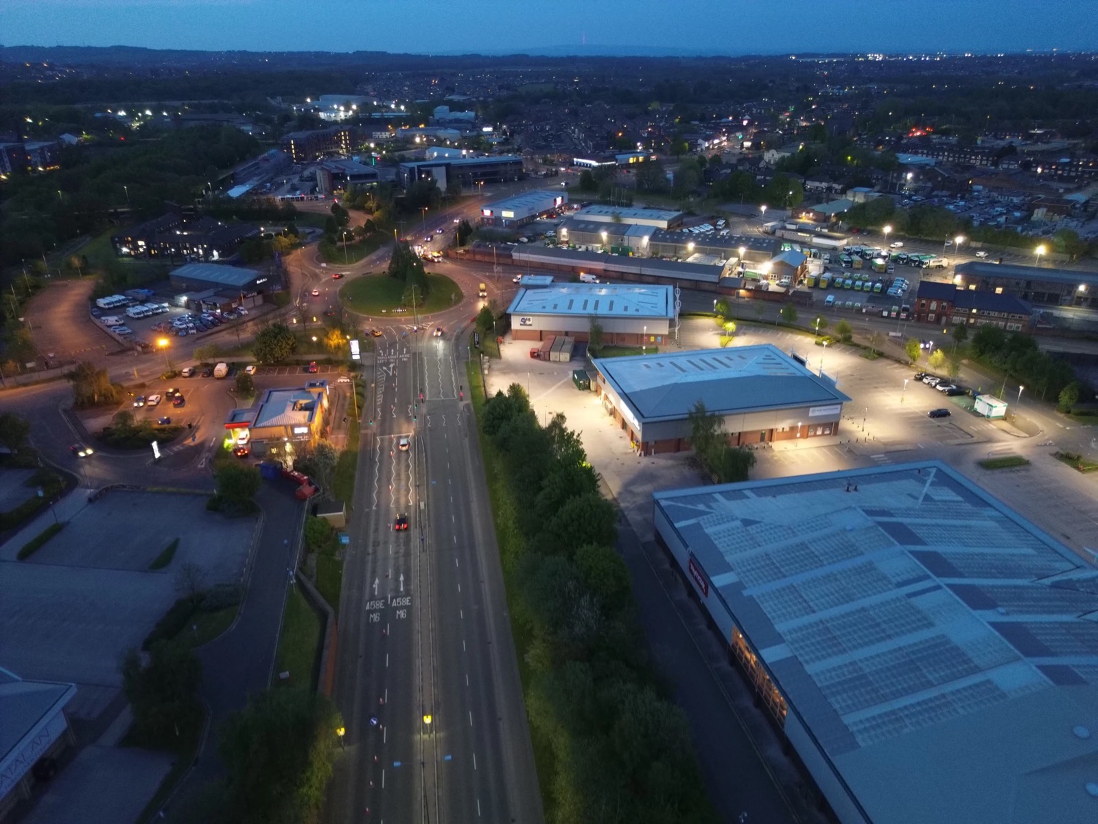 Drone view over roads and buildings at dusk