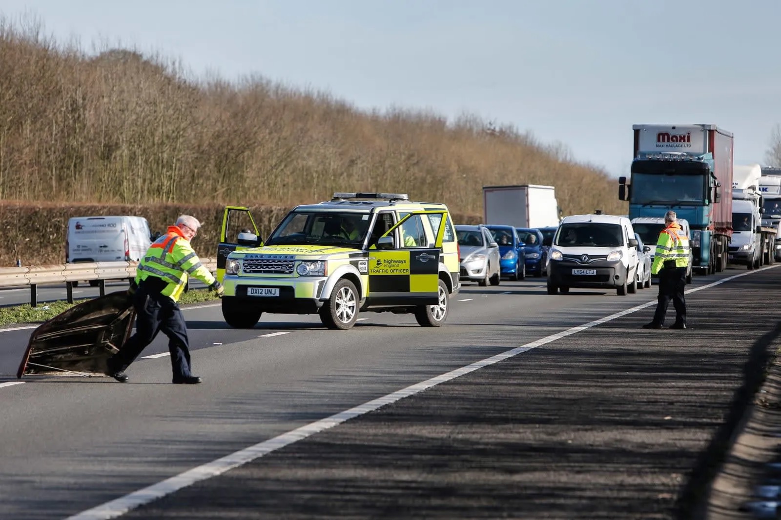 Traffic management operatives setting out a lane closure on a high-speed road